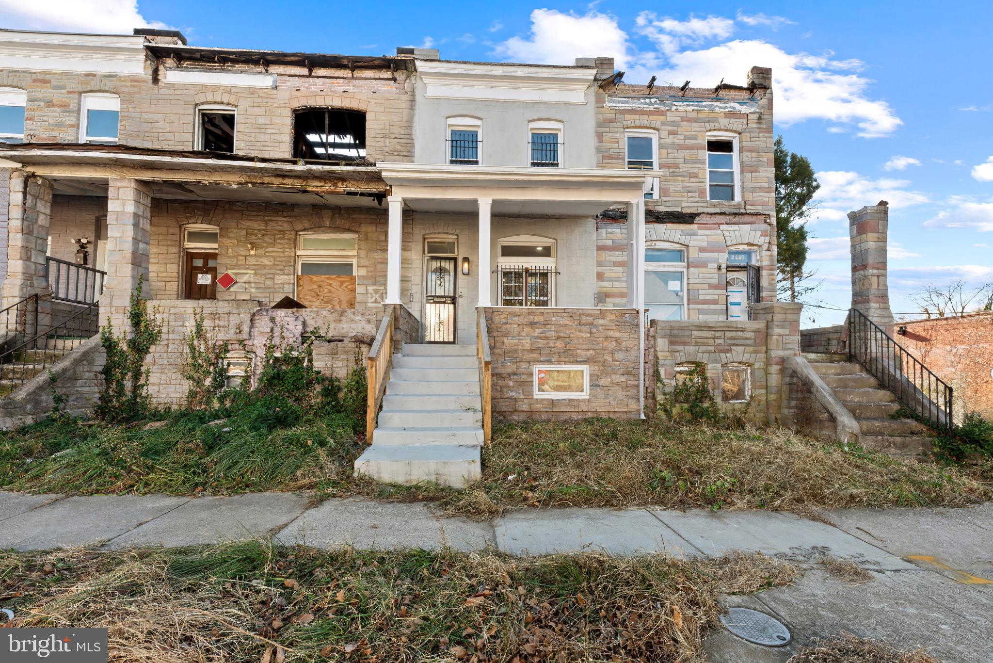 2419 Baker Street Baltimore, MD 21216 - Photo 39 of 40 a front view of a house with a yard
