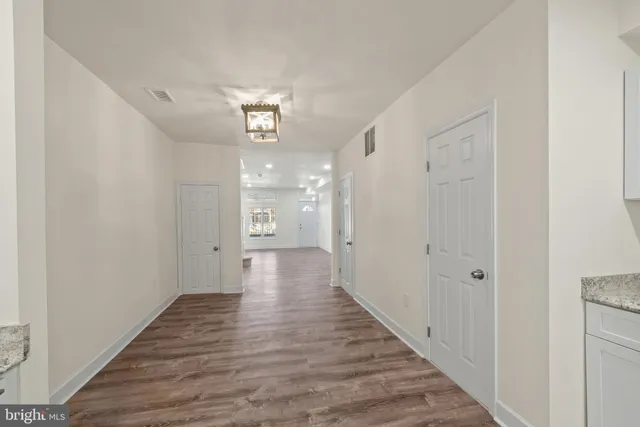 a view of a hallway with wooden floor