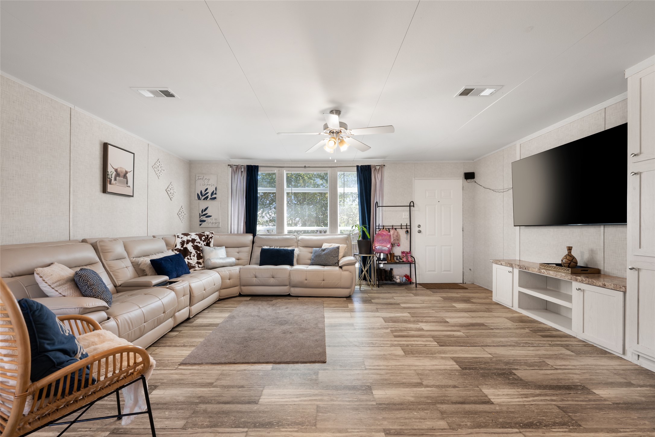 113 Sunflower Road Dale, TX 78616 - Photo 7 of 33 Durable plank flooring stretches across this open living space featuring a built-in media console.