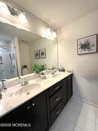 a bathroom with a sink double vanity and a mirror