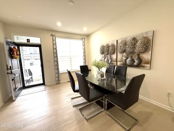 a dining room with furniture and wooden floor
