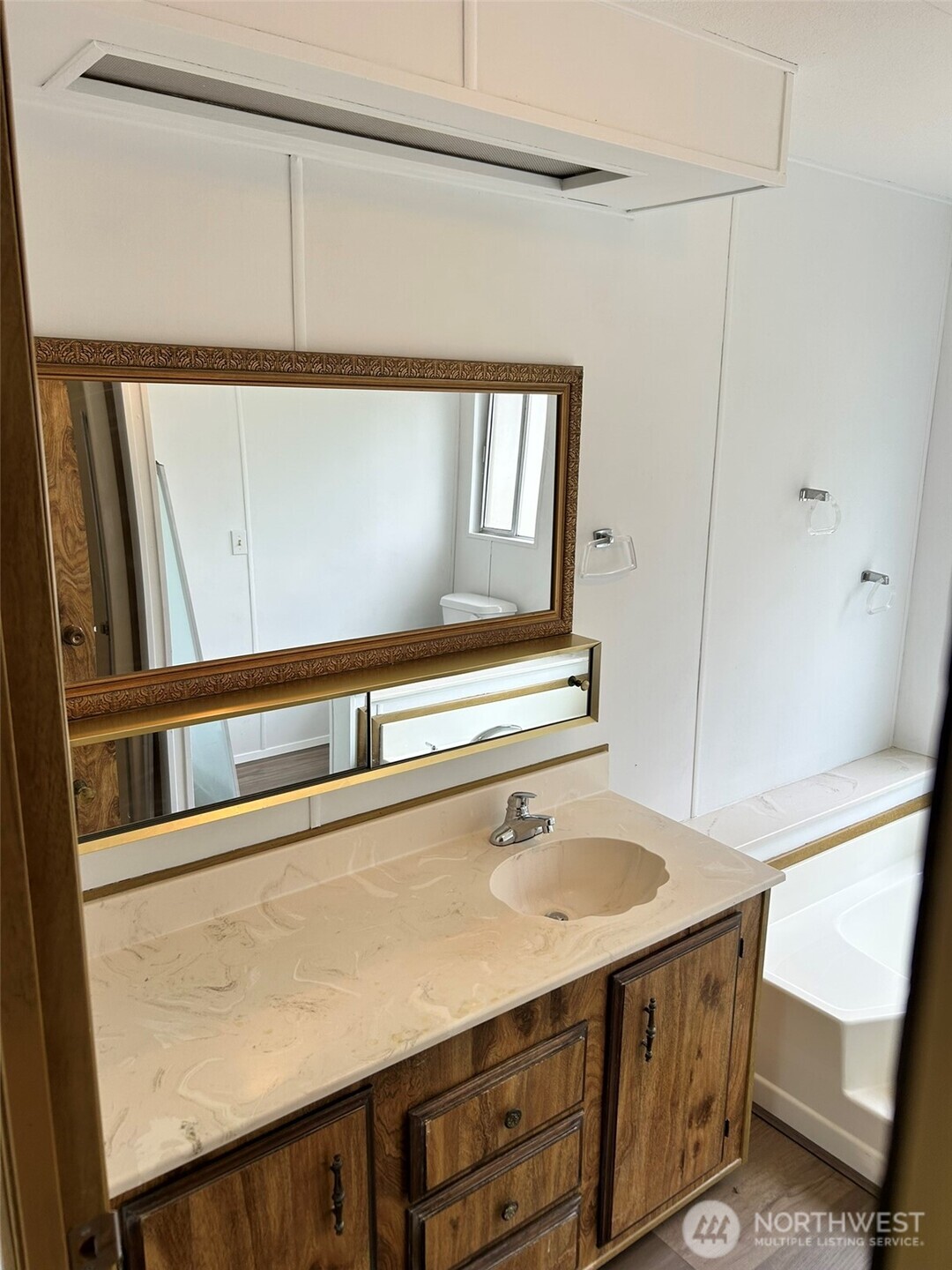 791 Elliot Court Sequim, WA 98382 - Photo 23 of 37 a utility room with a sink a refrigerator and window