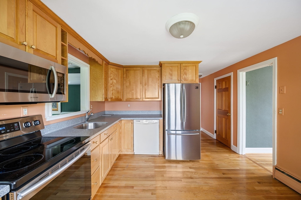 40 Bell Road Weymouth, MA 02188 - Photo 22 of 41 a kitchen with stainless steel appliances granite countertop a refrigerator a stove and a sink