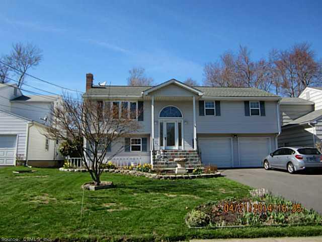 24 Mildred Road West Hartford, CT 06107 - Photo 1 of 1 a front view of a house with a garden and plants