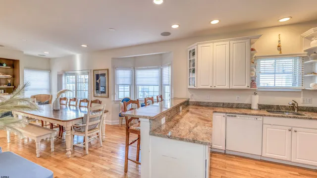 a kitchen with stainless steel appliances granite countertop a sink and cabinets