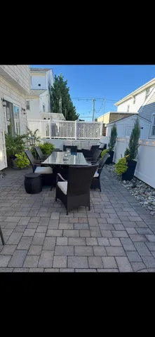 a view of a patio with couches and potted plants