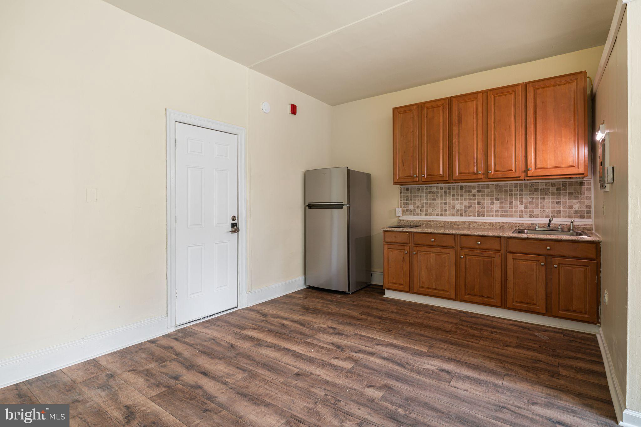 7153 Germantown Avenue, Unit 5 Philadelphia, PA 19119 - Photo 3 of 7 a kitchen with stainless steel appliances granite countertop a refrigerator sink and cabinets