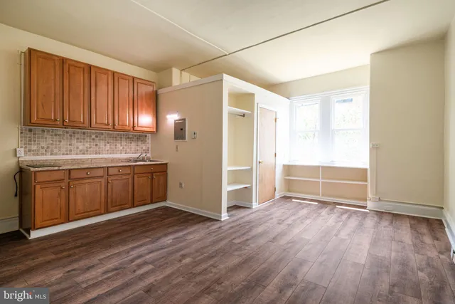a kitchen with a refrigerator and a sink