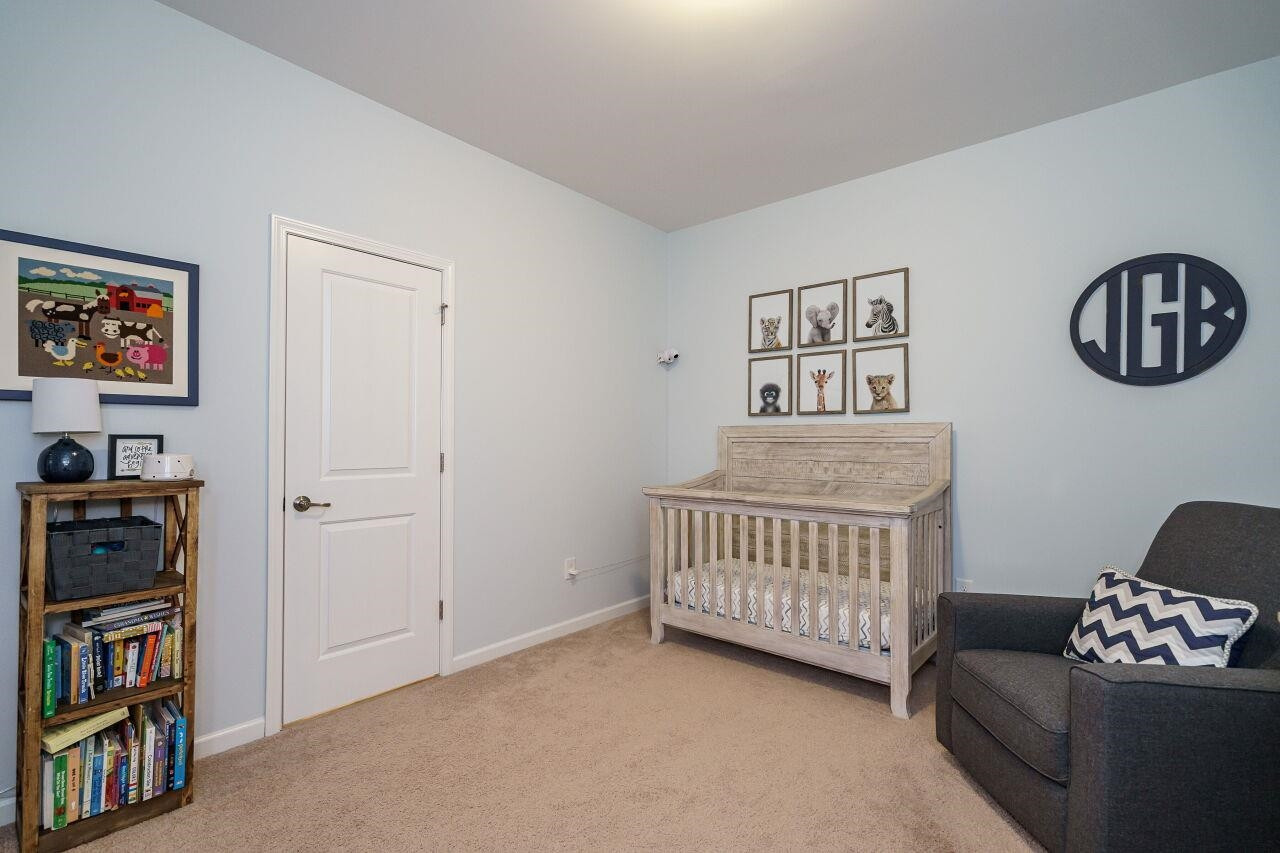 5602 Wade Park Boulevard Raleigh, NC 27607 - Photo 23 of 34 Upstairs bedroom with generous sized closet with wooden shelving and shared bath. Bedroom