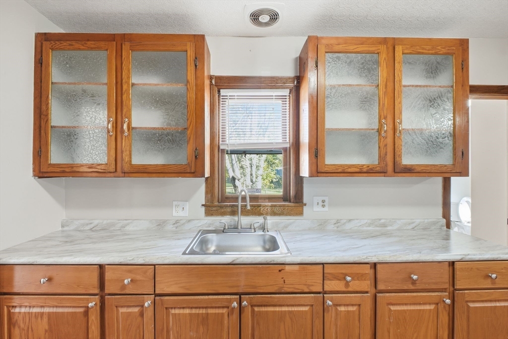 114 Connecticut Avenue West Springfield, MA 01089 - Photo 12 of 30 a bathroom with a granite countertop sink and a mirror