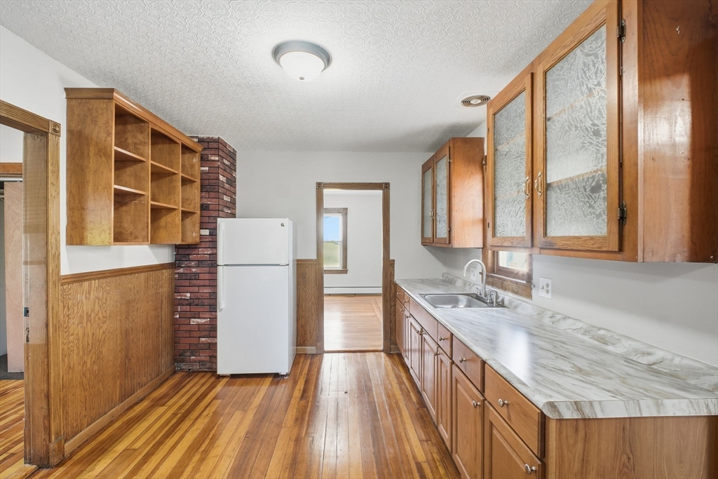 114 Connecticut Avenue West Springfield, MA 01089 - Photo 15 of 30 a kitchen with a sink stove and refrigerator