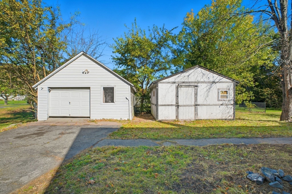 114 Connecticut Avenue West Springfield, MA 01089 - Photo 25 of 30 a front view of a house with a yard and garage