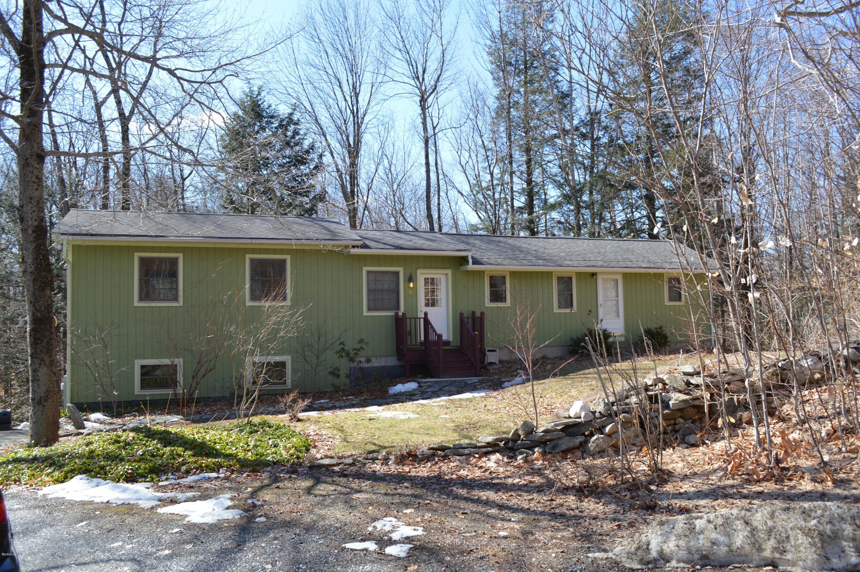 98 Wade Inn Road Becket, MA 01223 - Photo 14 of 30 a front view of a house with a yard covered with trees