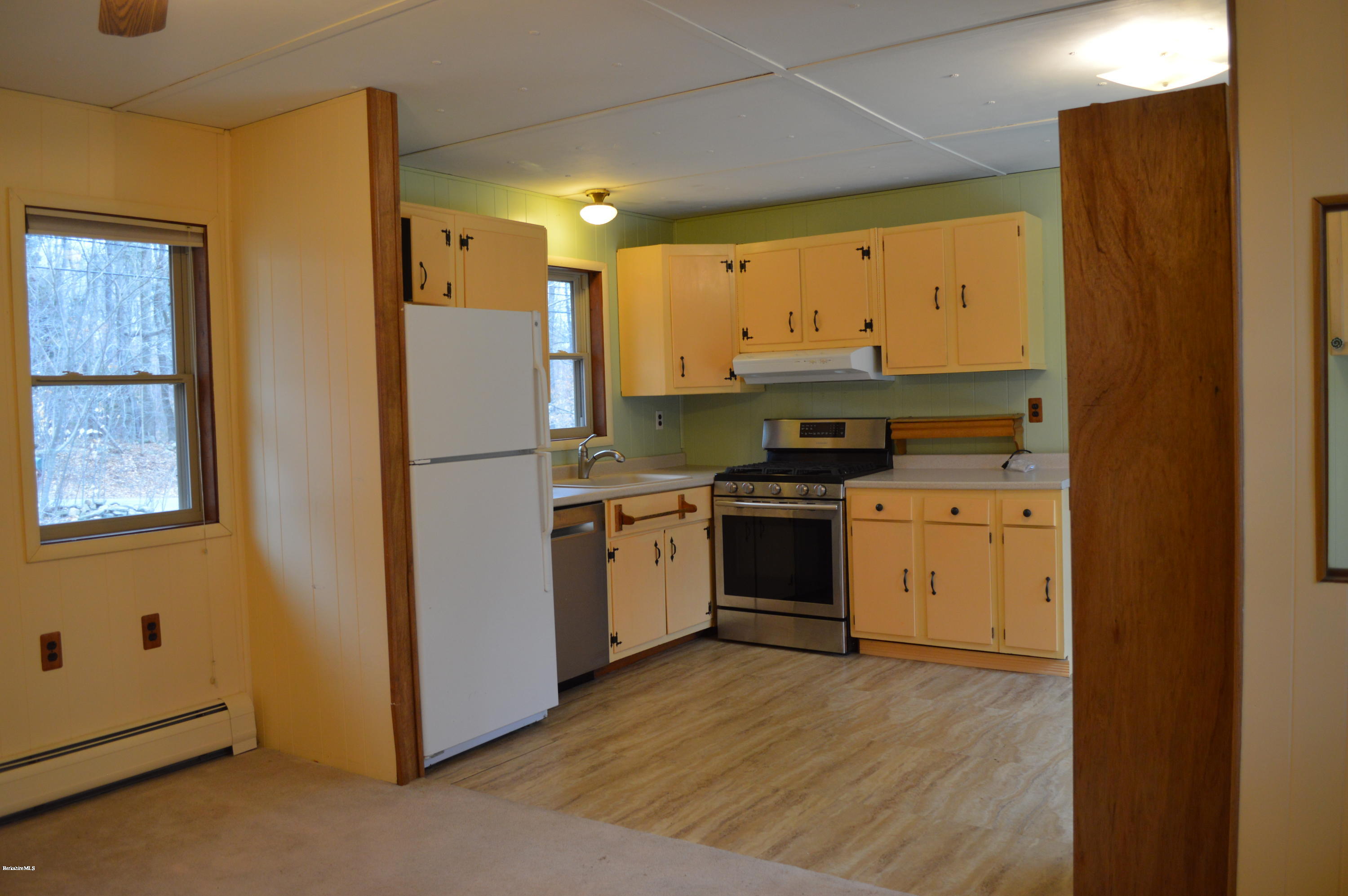 98 Wade Inn Road Becket, MA 01223 - Photo 3 of 30 a kitchen with a stove a sink and a refrigerator
