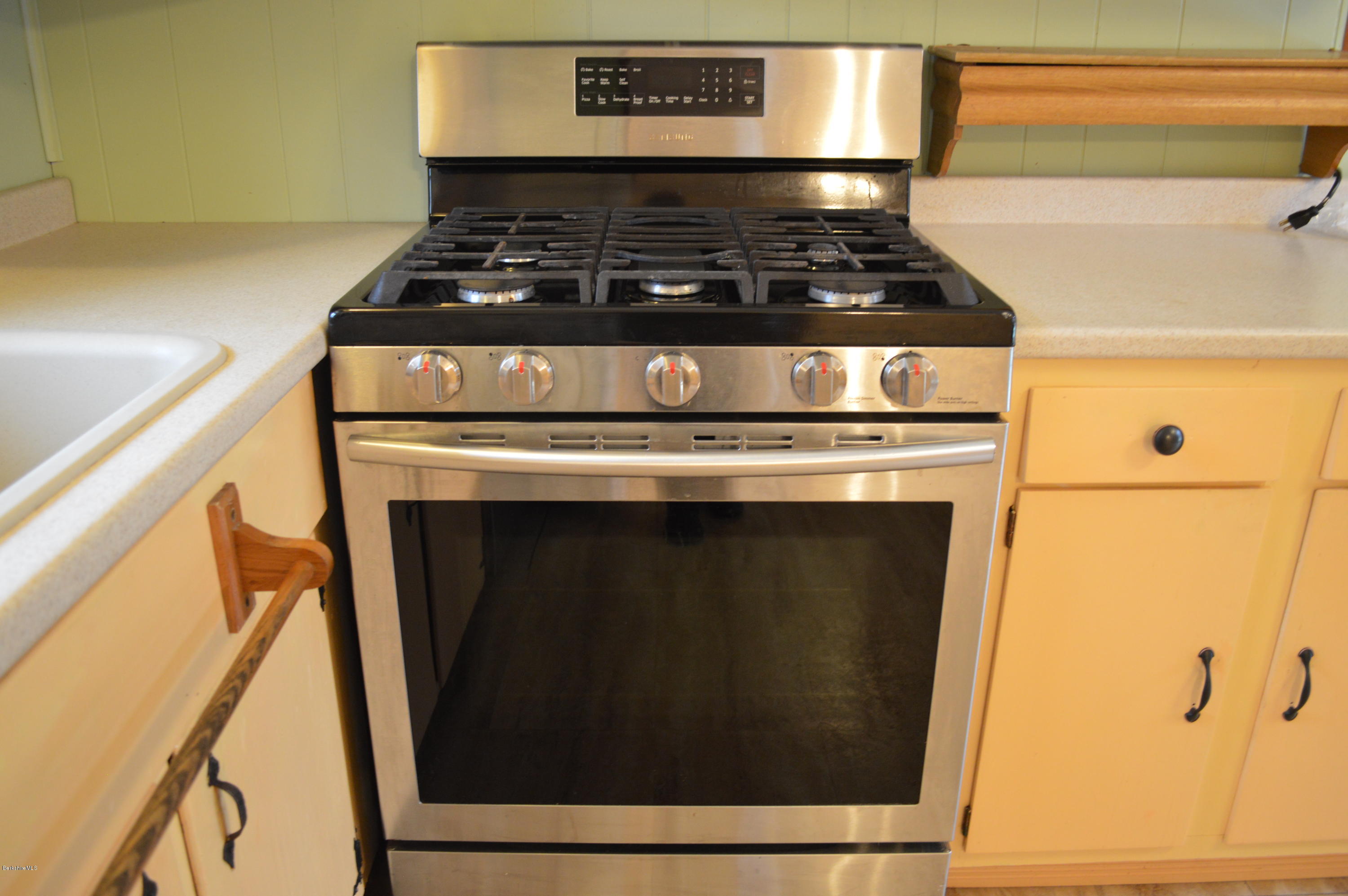 98 Wade Inn Road Becket, MA 01223 - Photo 9 of 30 a stove top oven sitting inside of a kitchen