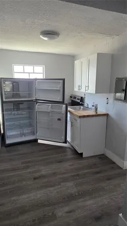 a kitchen with stainless steel appliances a stove refrigerator sink and cabinets