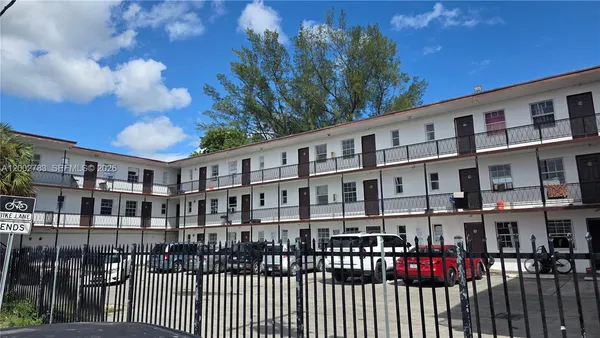a view of a brick building next to a yard