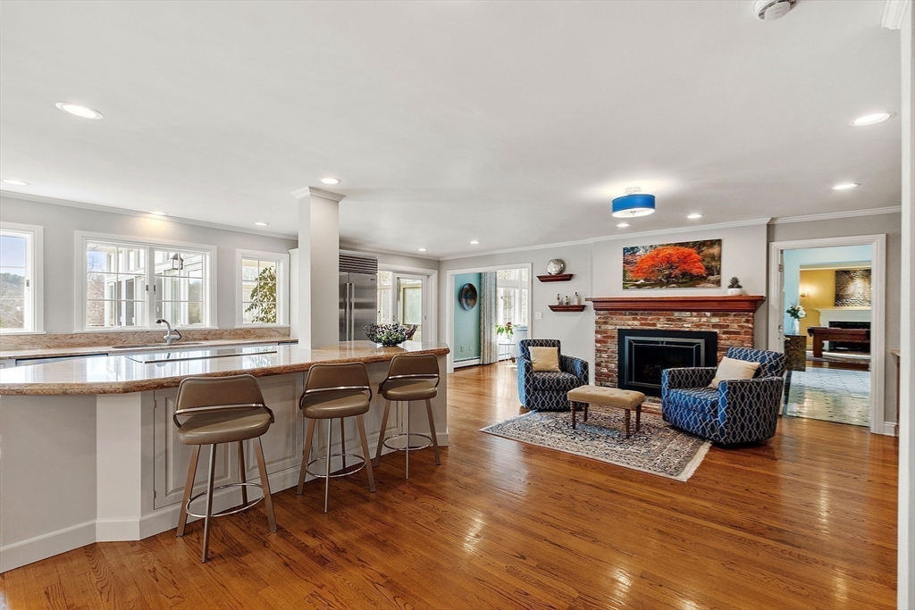 336 Lexington Road Concord, MA 01742 - Photo 20 of 41 a living room with furniture a fireplace and kitchen view