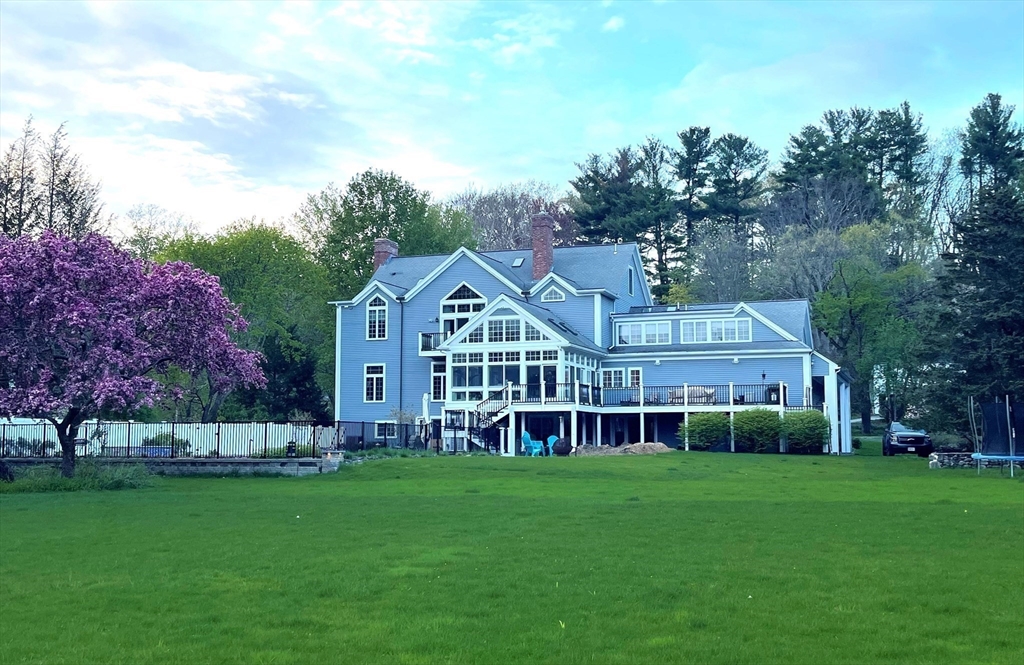 336 Lexington Road Concord, MA 01742 - Photo 2 of 41 a view of a house with a big yard and large trees