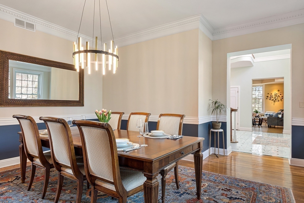 336 Lexington Road Concord, MA 01742 - Photo 22 of 41 a view of a dining room with furniture wooden floor and chandelier