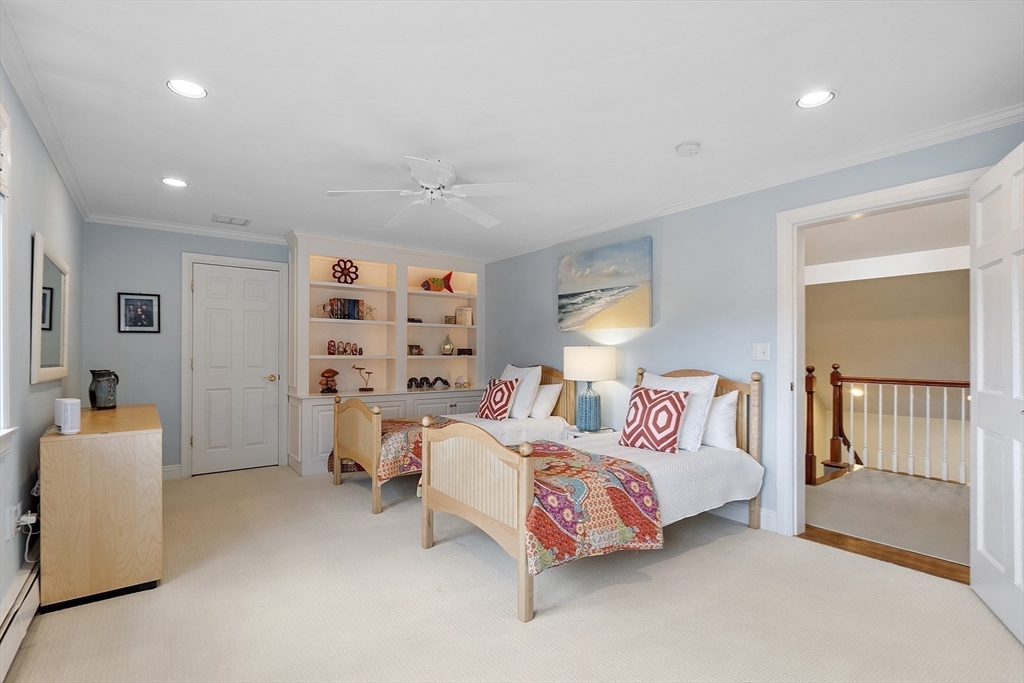 336 Lexington Road Concord, MA 01742 - Photo 30 of 41 a bedroom with furniture and a flat screen tv