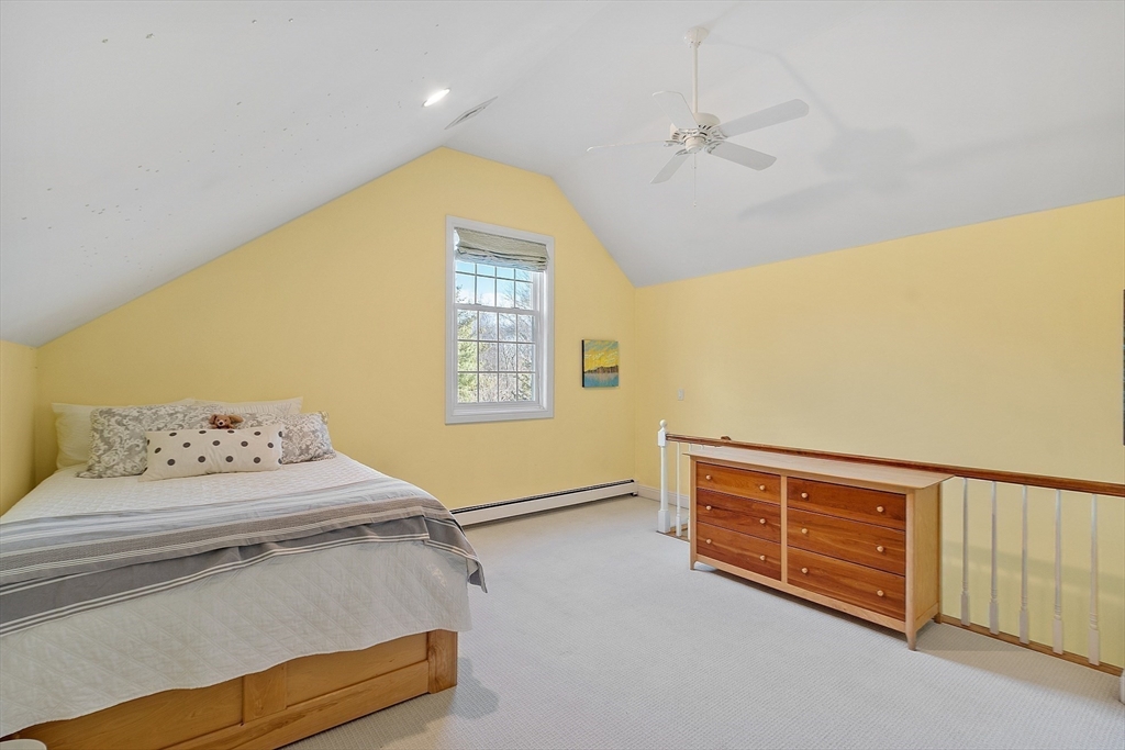 336 Lexington Road Concord, MA 01742 - Photo 33 of 41 a bedroom with a bed and a dresser
