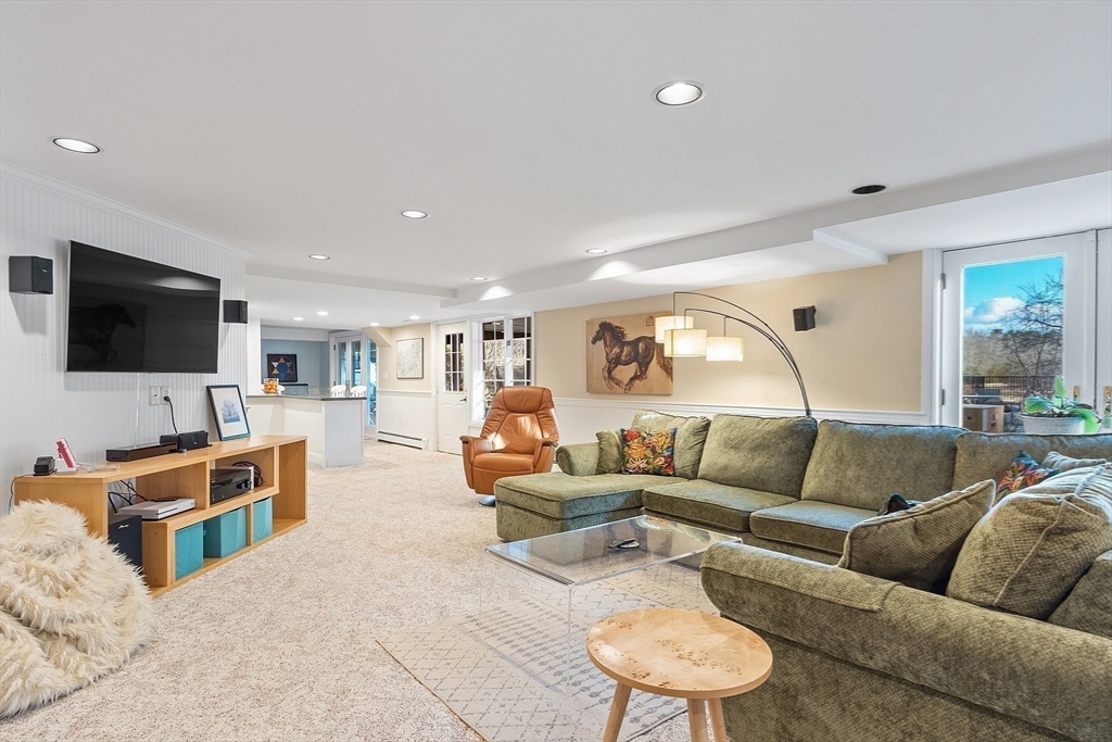 336 Lexington Road Concord, MA 01742 - Photo 36 of 41 a living room with furniture and a flat screen tv