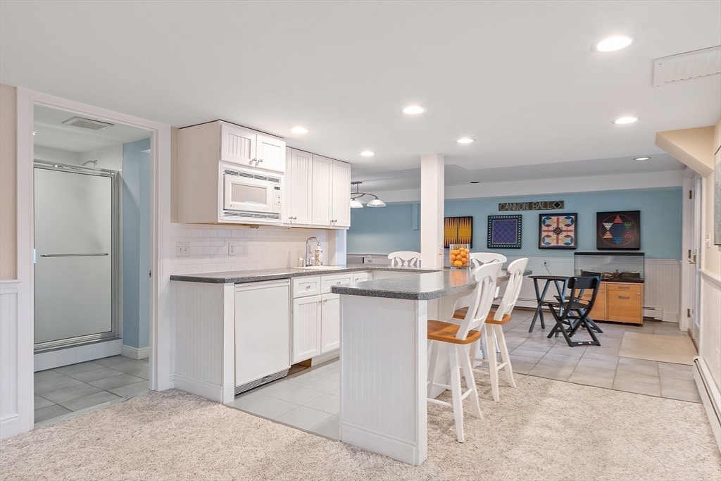 336 Lexington Road Concord, MA 01742 - Photo 38 of 41 a kitchen with white cabinets and refrigerator