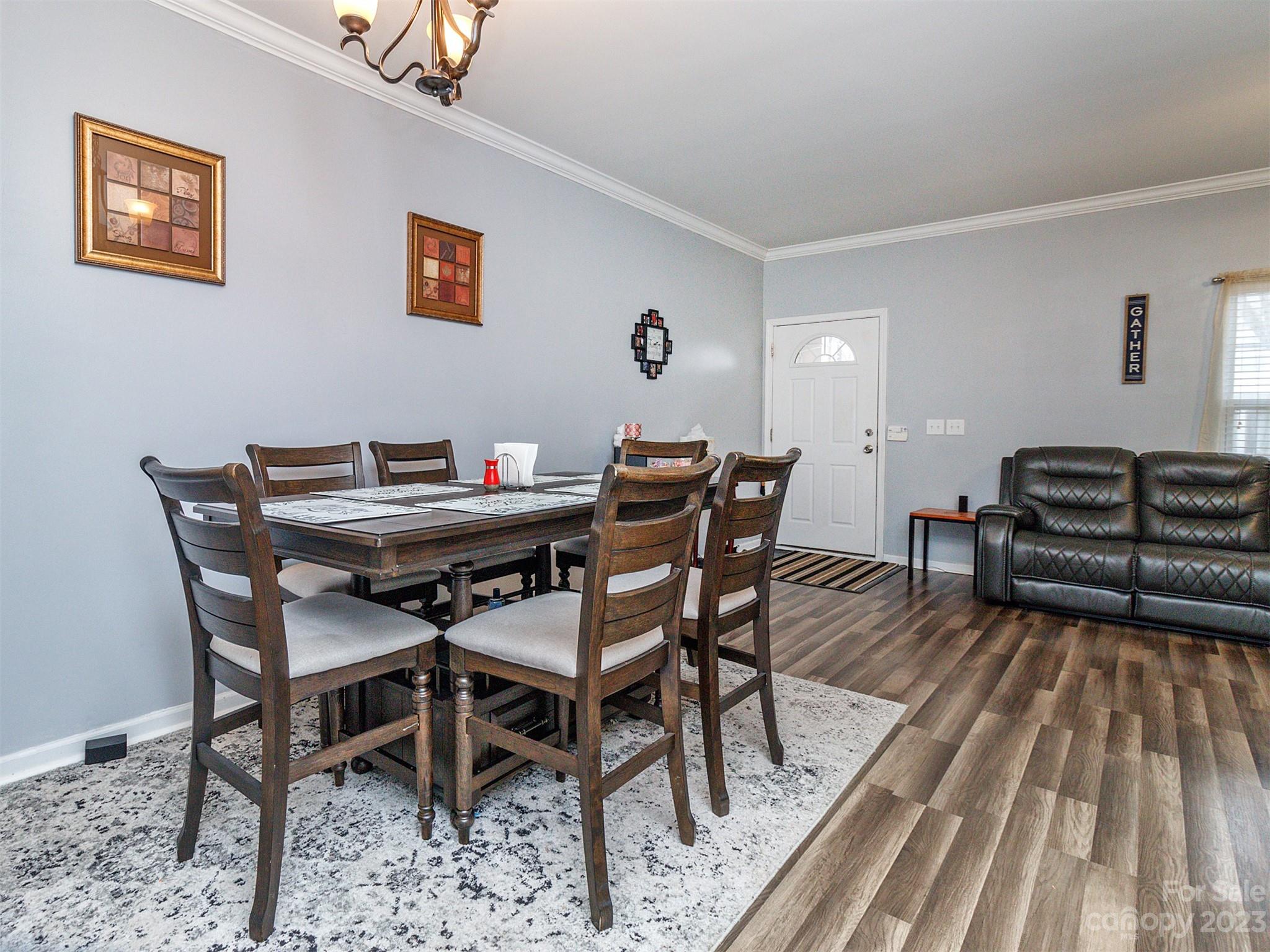 3053 Summerfield Ridge Lane Matthews, NC 28105 - Photo 13 of 37 a view of a dining room with furniture and wooden floor