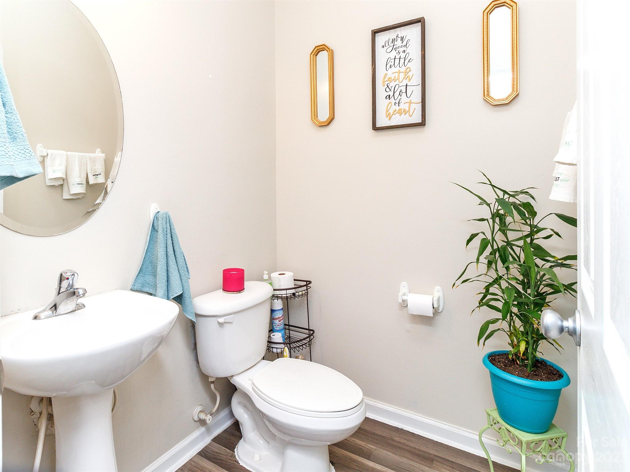 3053 Summerfield Ridge Lane Matthews, NC 28105 - Photo 14 of 37 a bathroom with a toilet a sink and a mirror