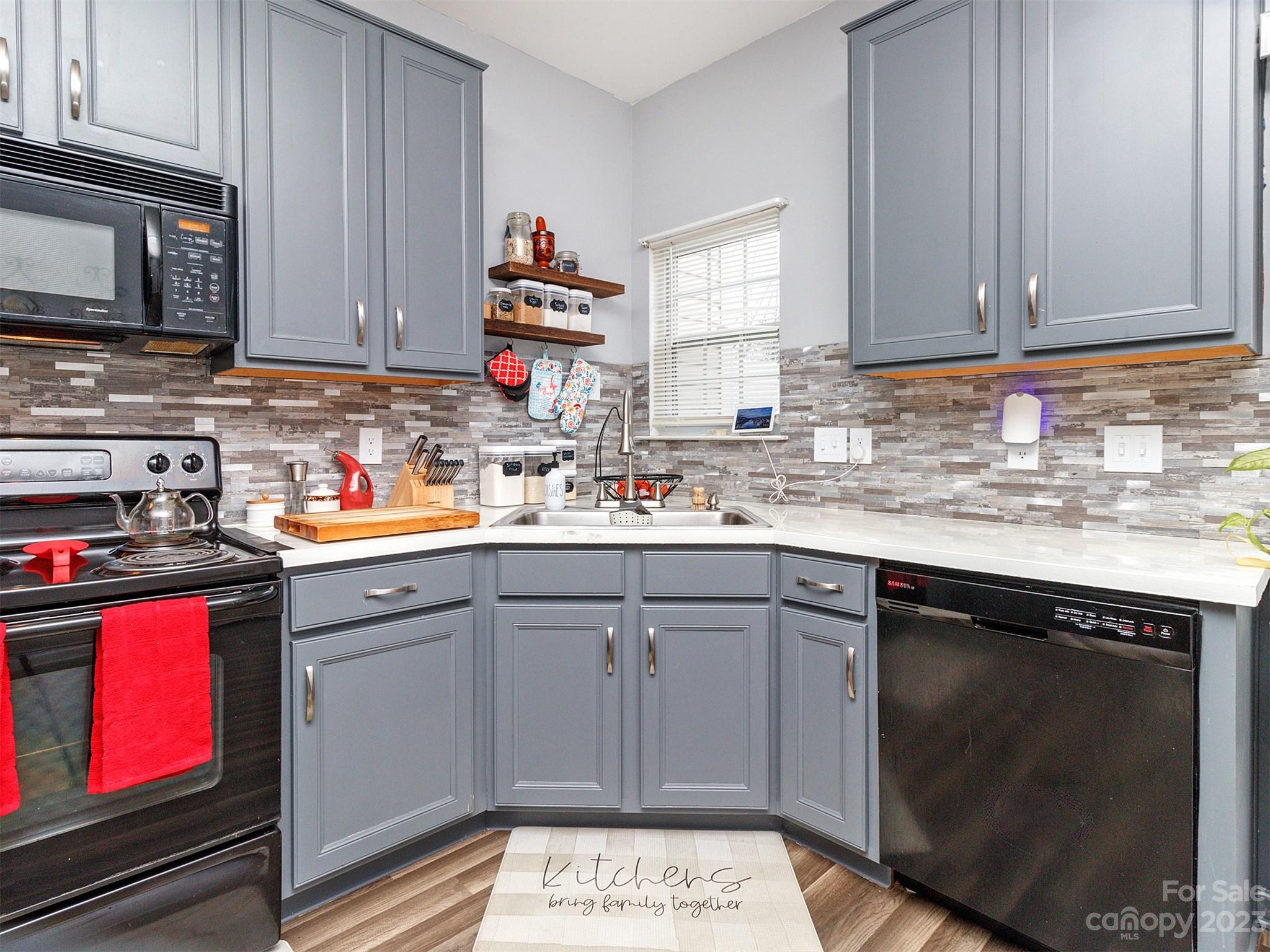 3053 Summerfield Ridge Lane Matthews, NC 28105 - Photo 17 of 37 a kitchen with stainless steel appliances granite countertop a sink stove and cabinets