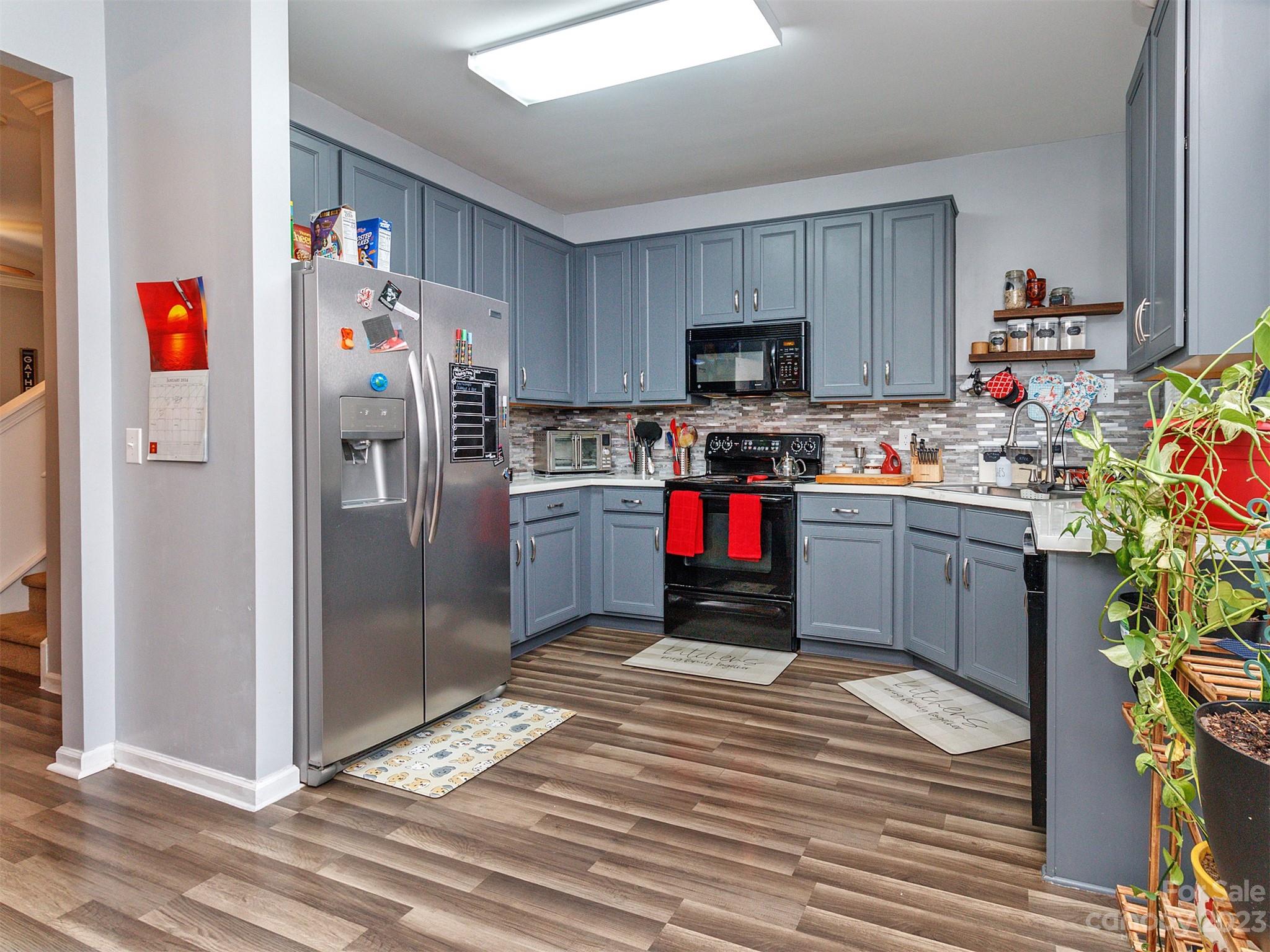 3053 Summerfield Ridge Lane Matthews, NC 28105 - Photo 18 of 37 a kitchen with stainless steel appliances a stove refrigerator and a sink