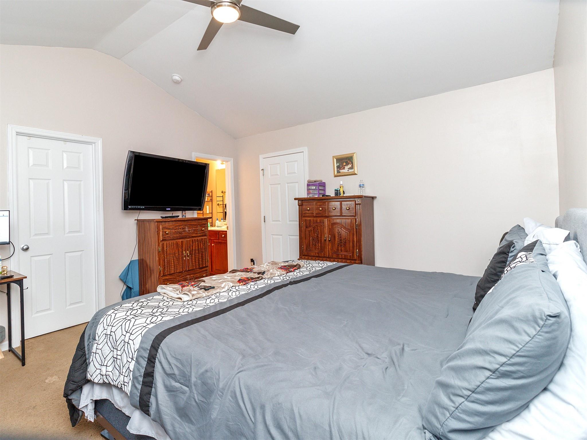 3053 Summerfield Ridge Lane Matthews, NC 28105 - Photo 24 of 37 a bedroom with a bed and a flat screen tv