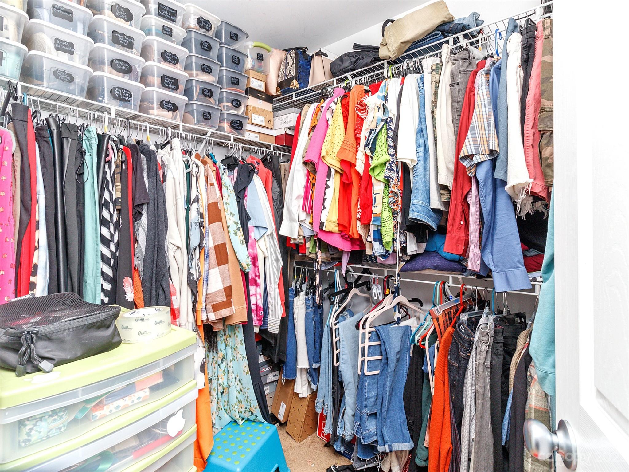 3053 Summerfield Ridge Lane Matthews, NC 28105 - Photo 27 of 37 a view of walk in closet with clothes
