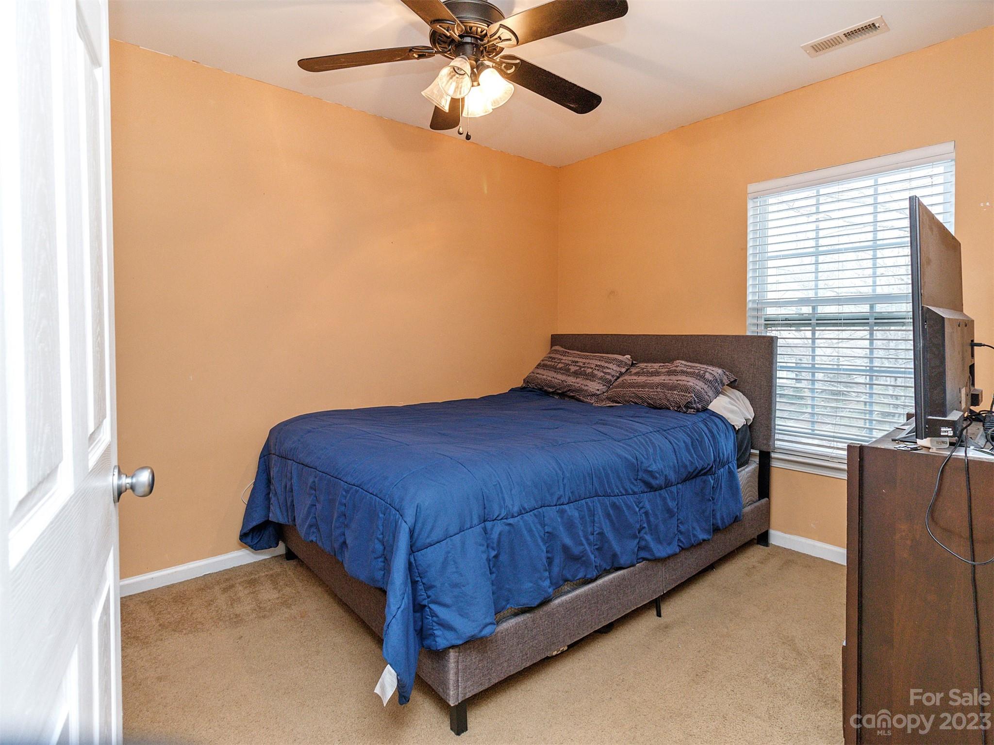 3053 Summerfield Ridge Lane Matthews, NC 28105 - Photo 28 of 37 a bedroom with a bed and a chandelier