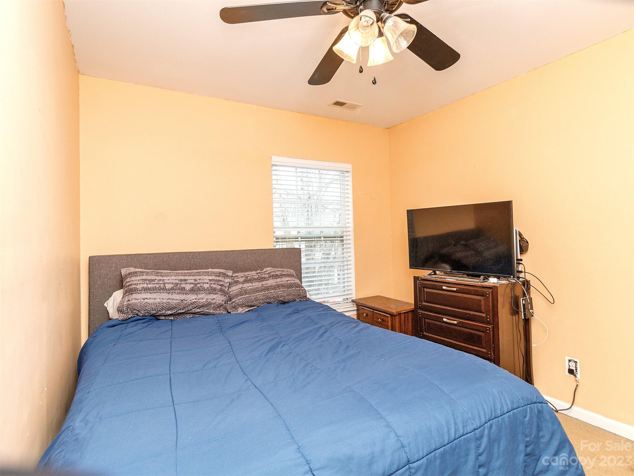 3053 Summerfield Ridge Lane Matthews, NC 28105 - Photo 29 of 37 a bedroom with a bed and flat screen tv