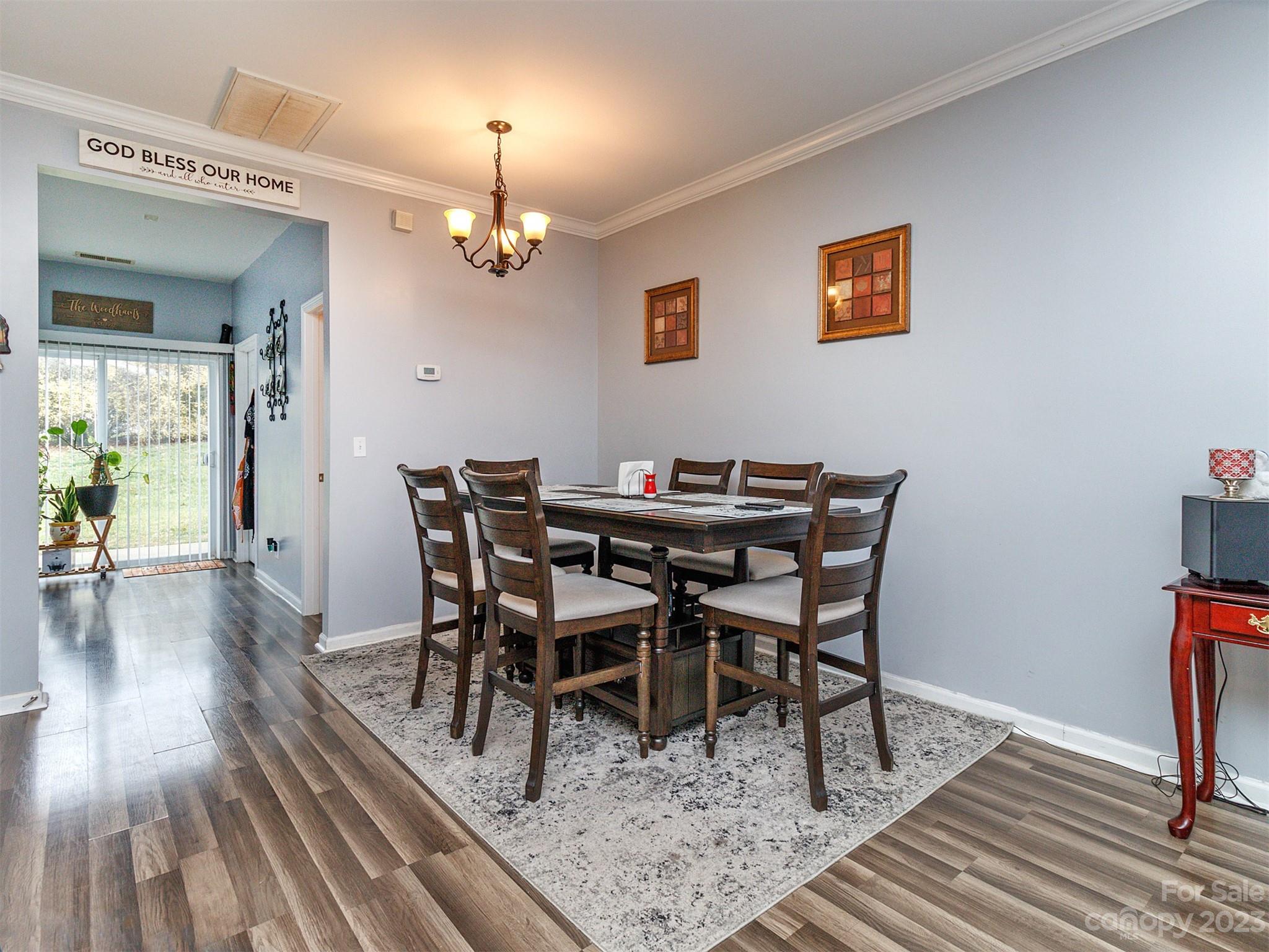3053 Summerfield Ridge Lane Matthews, NC 28105 - Photo 10 of 37 a view of a dining room with furniture wooden floor and chandelier
