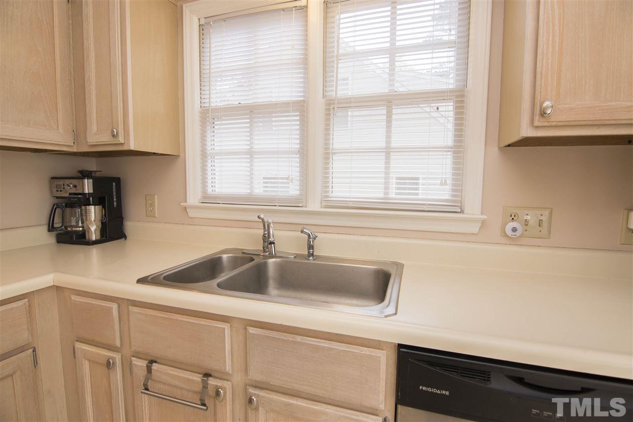 4416 Emmit Drive Raleigh, NC 27604 - Photo 11 of 28 a kitchen with stainless steel appliances granite countertop white cabinets and a sink
