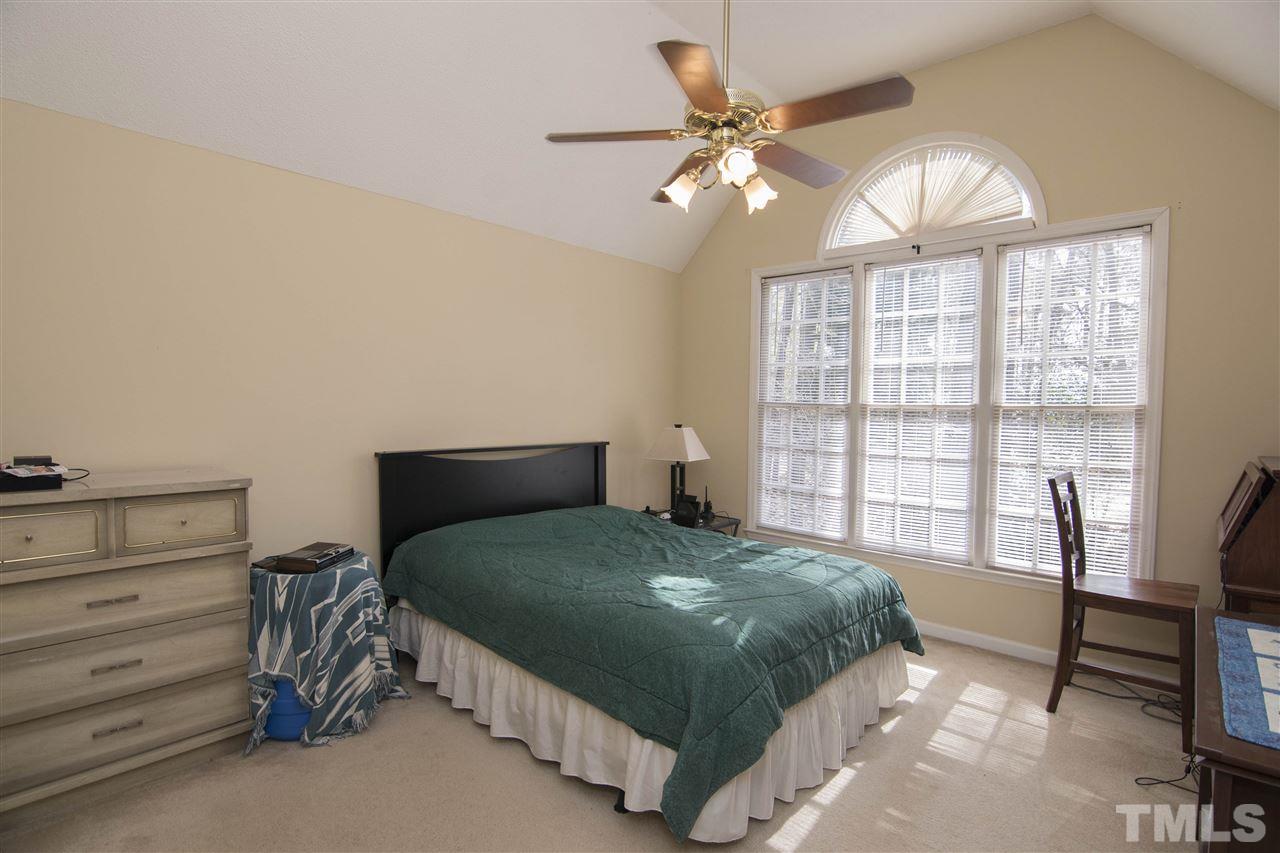 4416 Emmit Drive Raleigh, NC 27604 - Photo 12 of 28 a bedroom with a bed a table and chair
