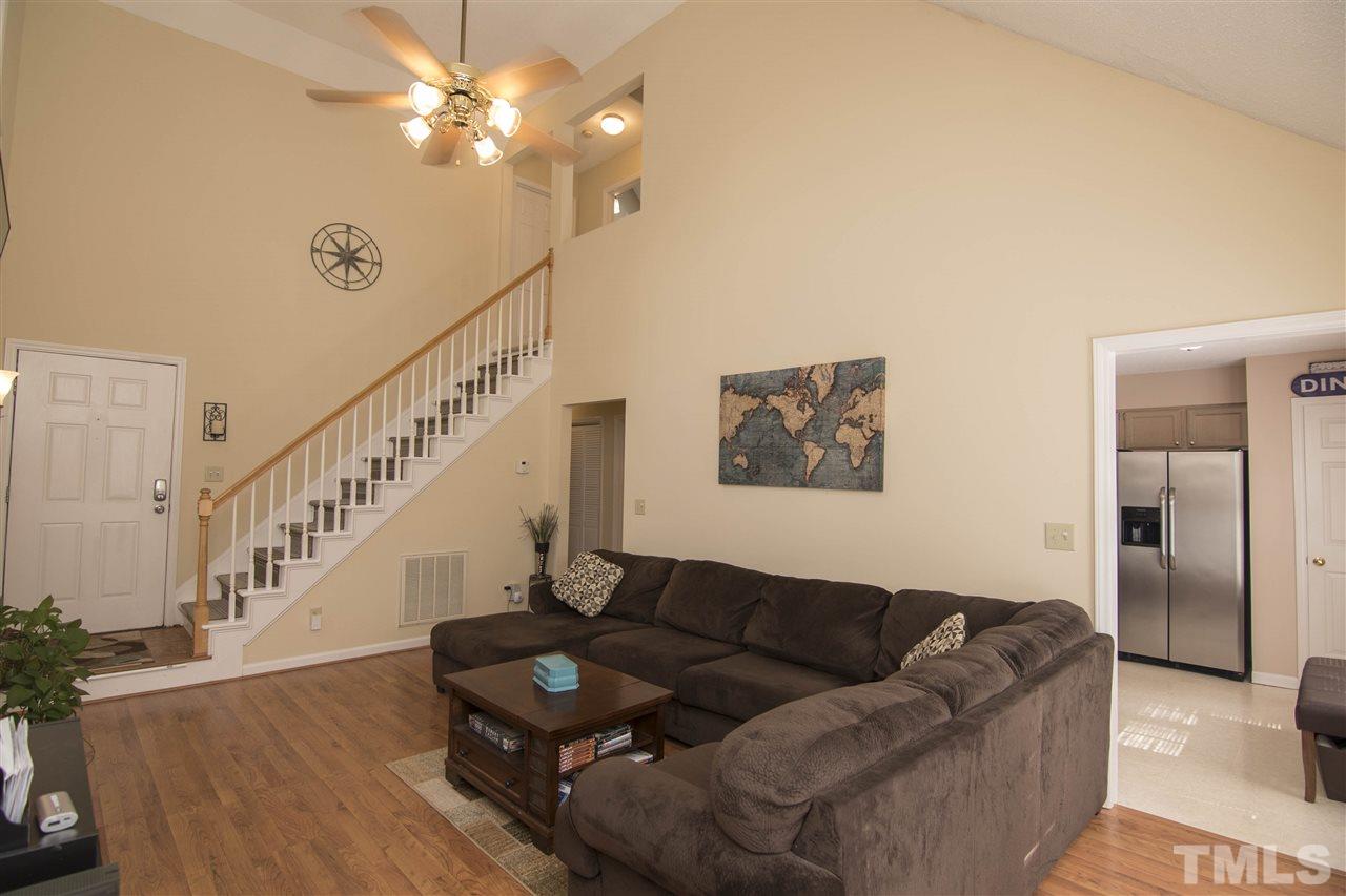 4416 Emmit Drive Raleigh, NC 27604 - Photo 6 of 28 a living room with furniture and a chandelier