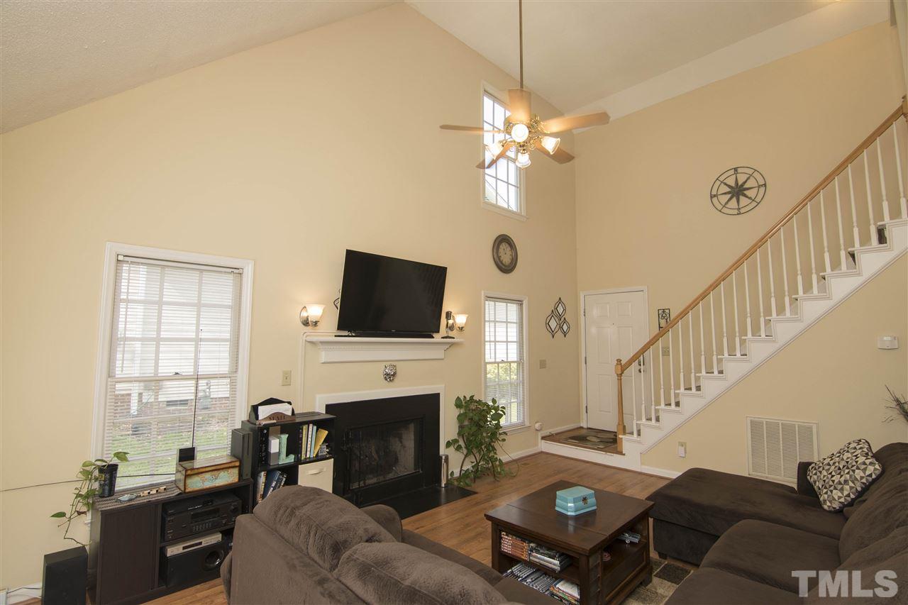 4416 Emmit Drive Raleigh, NC 27604 - Photo 7 of 28 a living room with furniture a fireplace and a flat screen tv
