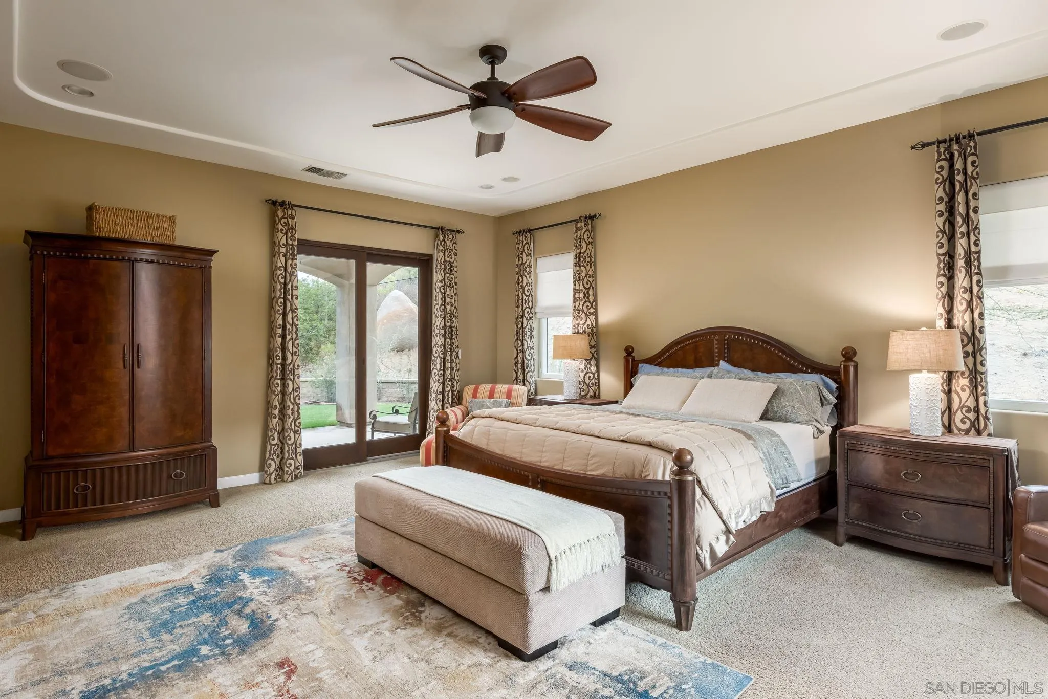 3132 Via Asoleado Alpine, CA 91901 - Photo 21 of 58 a spacious bedroom with a bed a dresser and a chandelier