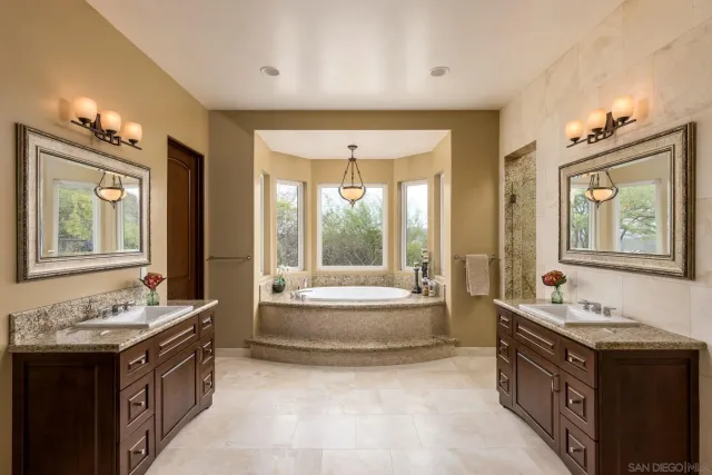 a bathroom with a granite countertop toilet sink and mirror