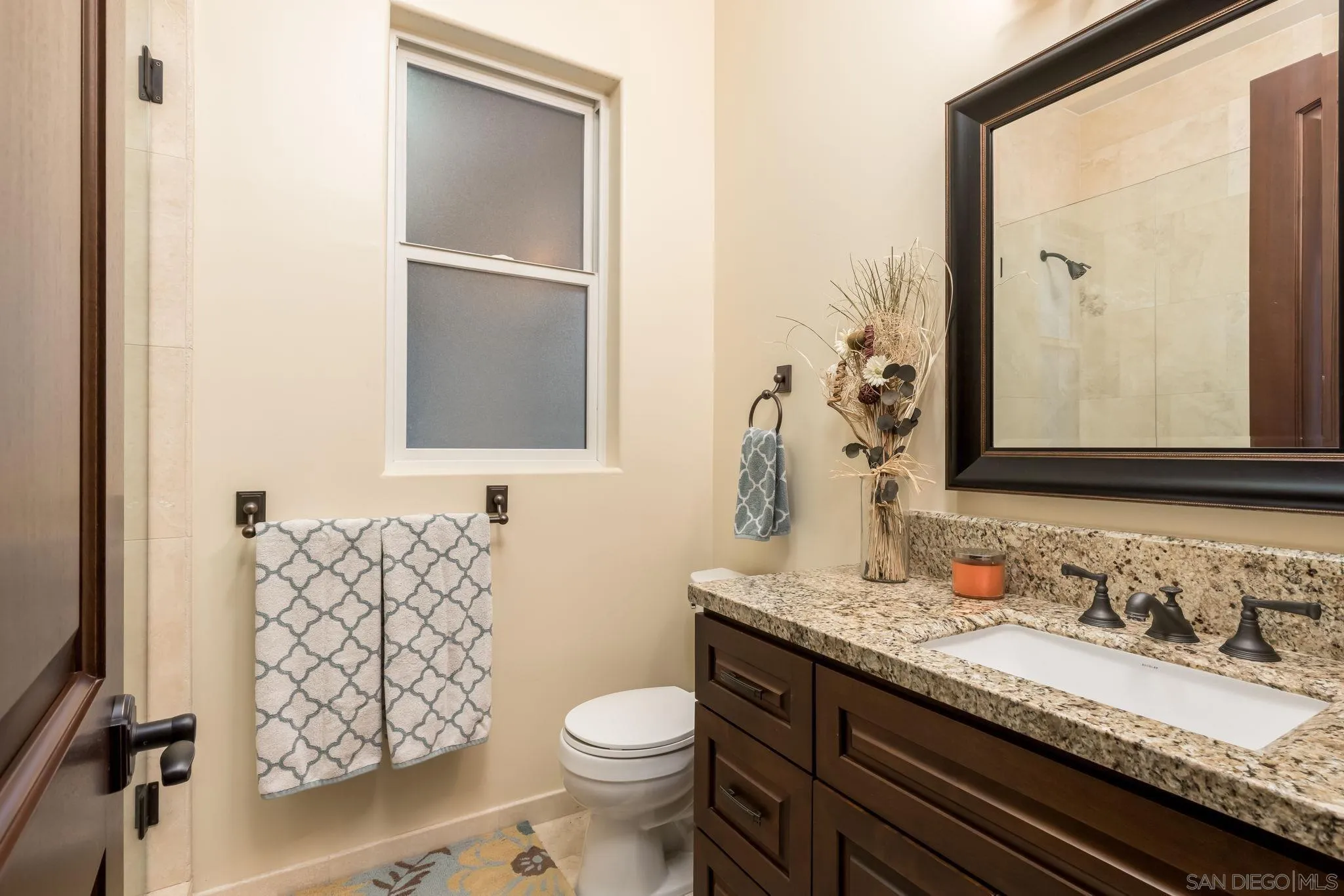 3132 Via Asoleado Alpine, CA 91901 - Photo 28 of 58 a bathroom with a granite countertop toilet sink and mirror