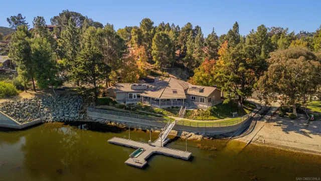 a view of a wooden house with a yard