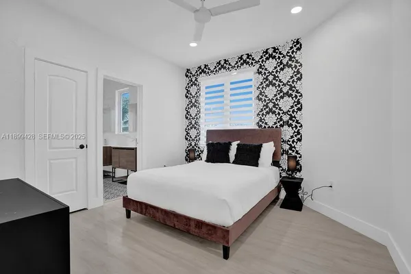 a bedroom with bed and a window