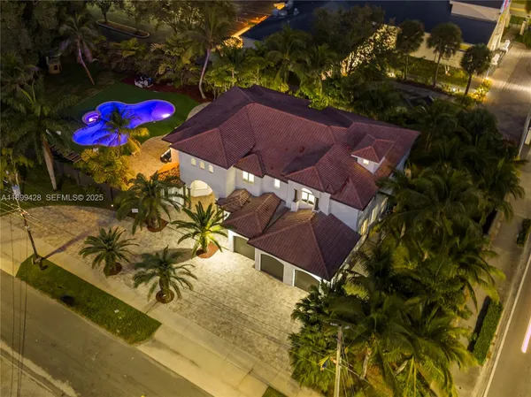 a view of a pool with table and chairs