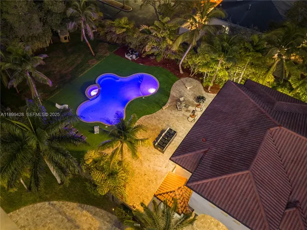 an aerial view of a house with garden space and street view