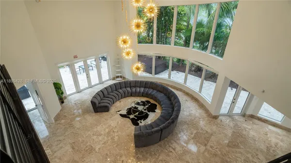 a living room with furniture ceiling fan and a rug