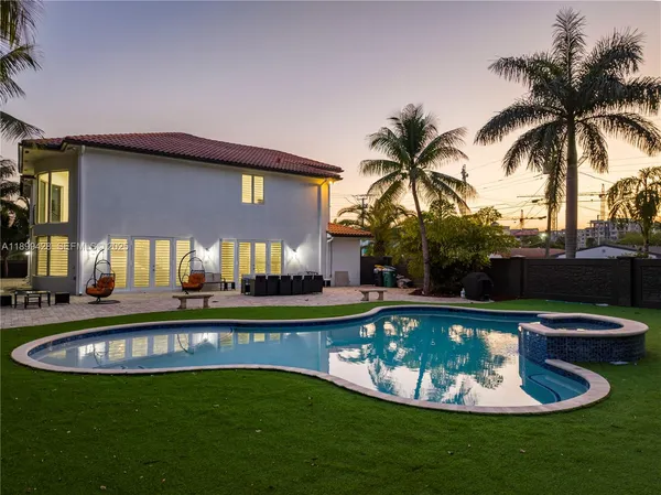an aerial view of a house with a swimming pool
